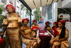 Women in similar clothing sit together