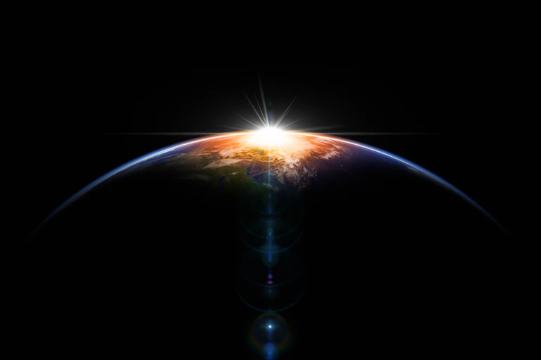 A hemisphere of a planet shown against a bright object in the background