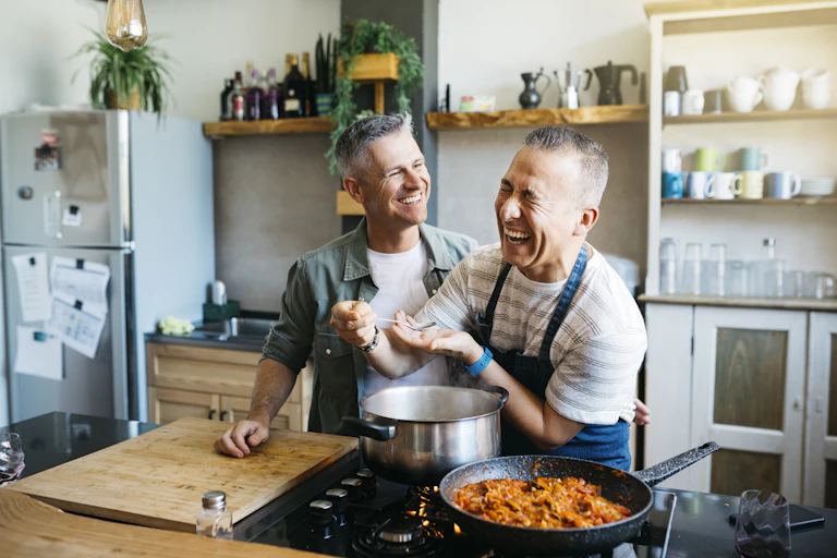Two men cooking dinner