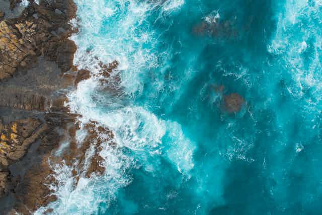 aerial view of rocky coast with ocean waves