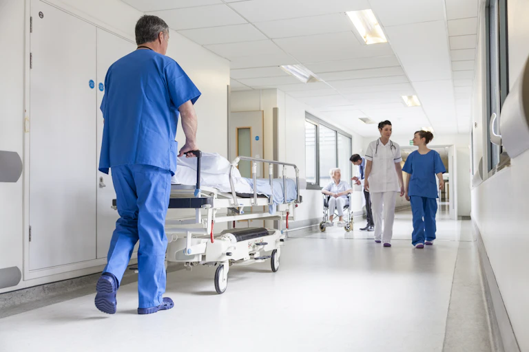 Nurse pushes hospital bed