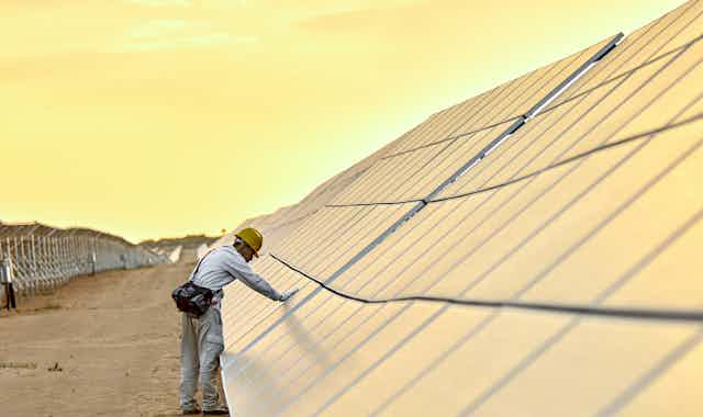 engineer inspecting solar panels