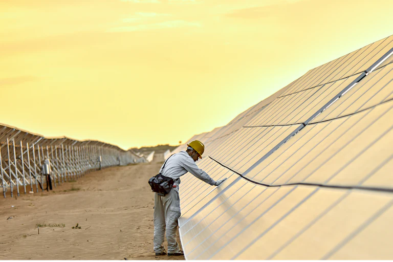 engineer inspecting solar panels