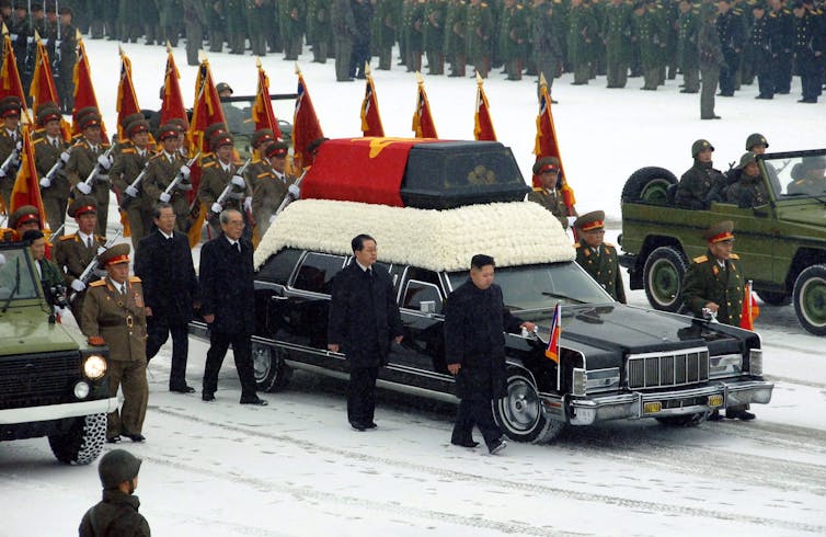 Kim Jong-un and his uncle Jang Song-thaek walk beside a hearse at the funeral of Kim Jong-il in Pyongyang, December 2011.