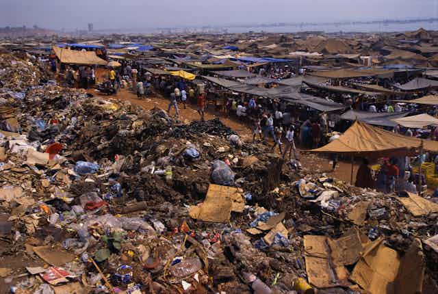 A huge garbage dump next to market stalls in Angola