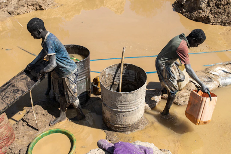 Two young people beside a mine