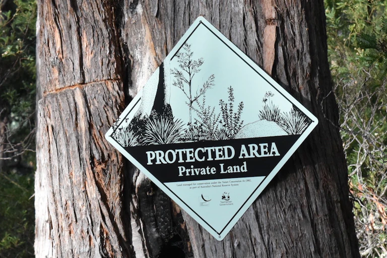A sign reading 'PROTECTED AREA - Private land'
