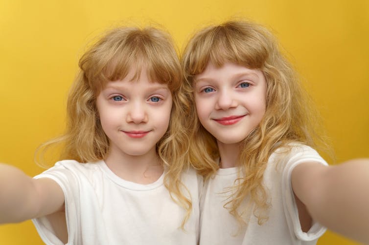 Young identical blond twins.