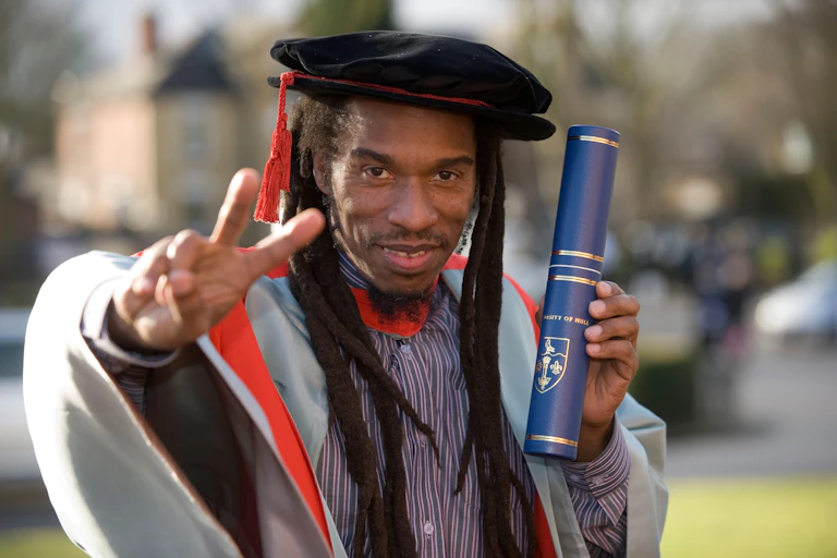 Benjamin Zephaniah holds up a scroll.