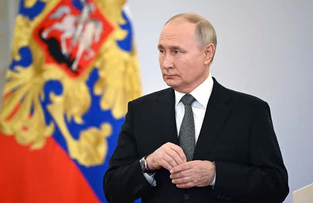 Vladimr Putin in a dark suit.