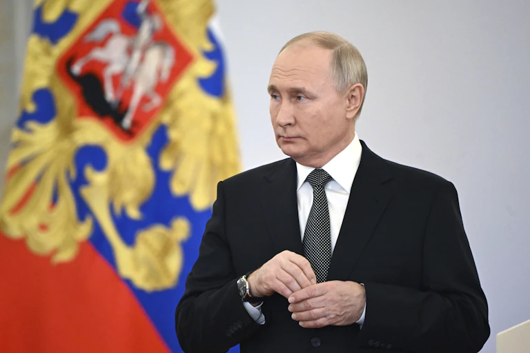 Vladimr Putin in a dark suit.
