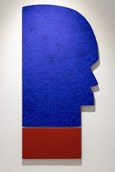 An artwork in blue and red showing what looks like a human profile, but graphic and abstract.