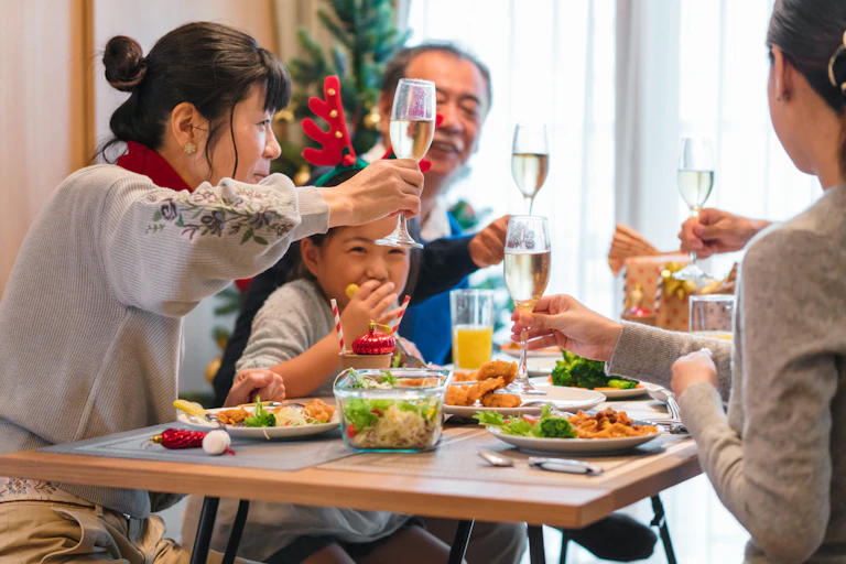 family toasting with champagne at a Christmas meal