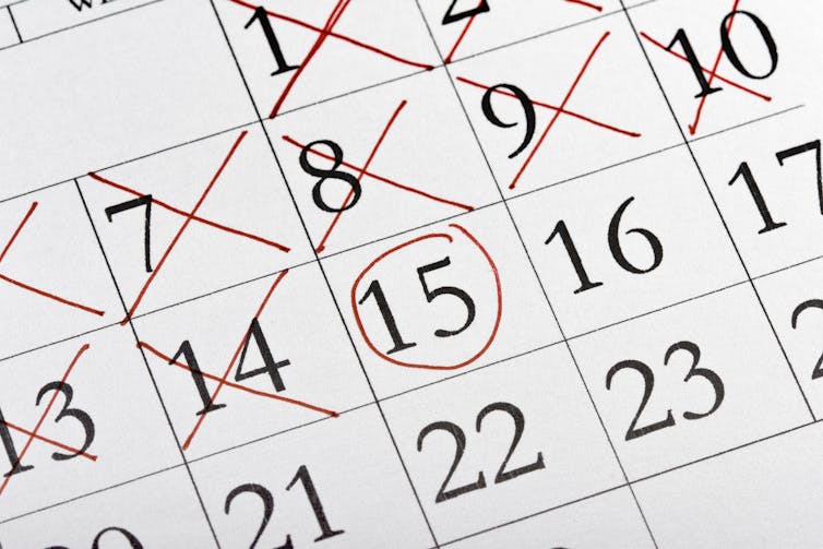 calendar with red X's crossing off days and one date circled