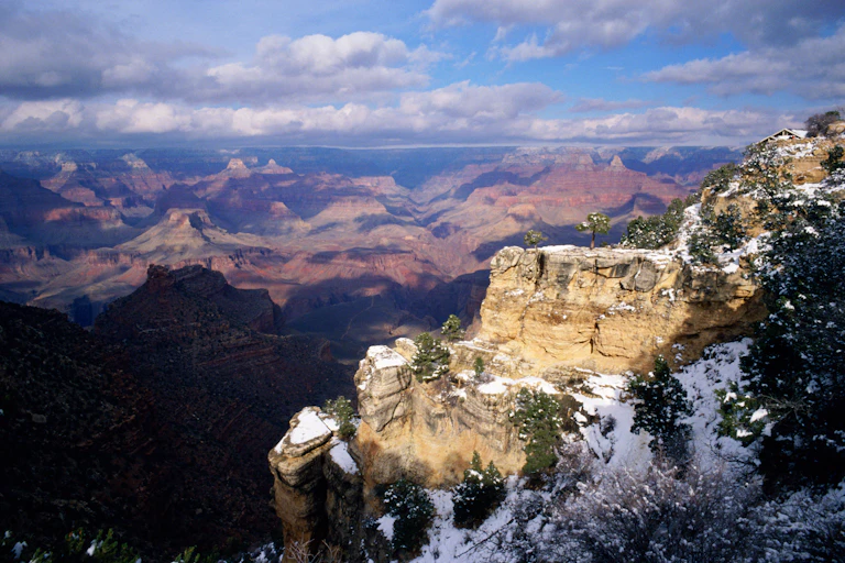 Snow covers a part of steep rocky mountains