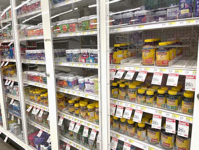 Vitamins and food supplements in locked cases with glass doors.