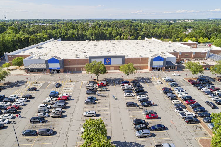 A large Walmart store fronted by an expansive parking lot.