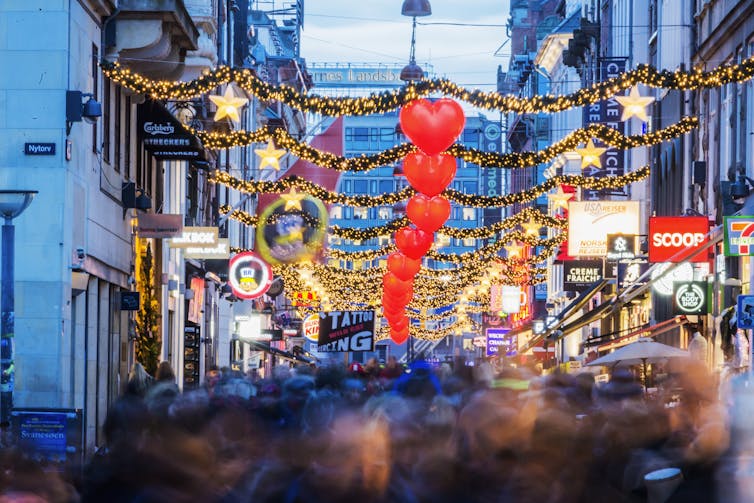 busy city street with lights and holiday decorations