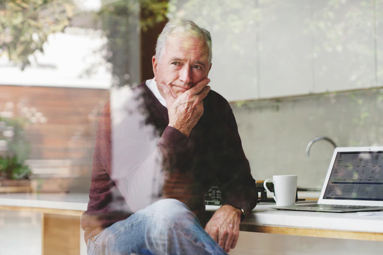 senior businessman at kitchen table planning,