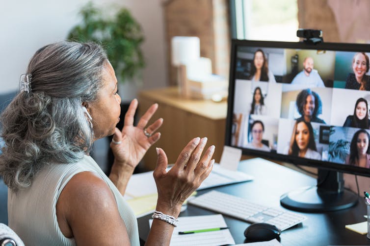 Older woman talking to people on a video conference