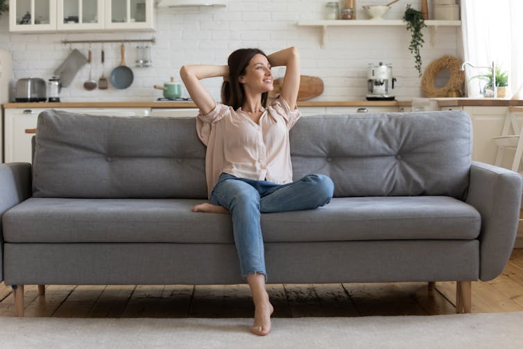 A smiling woman sitting on a couch