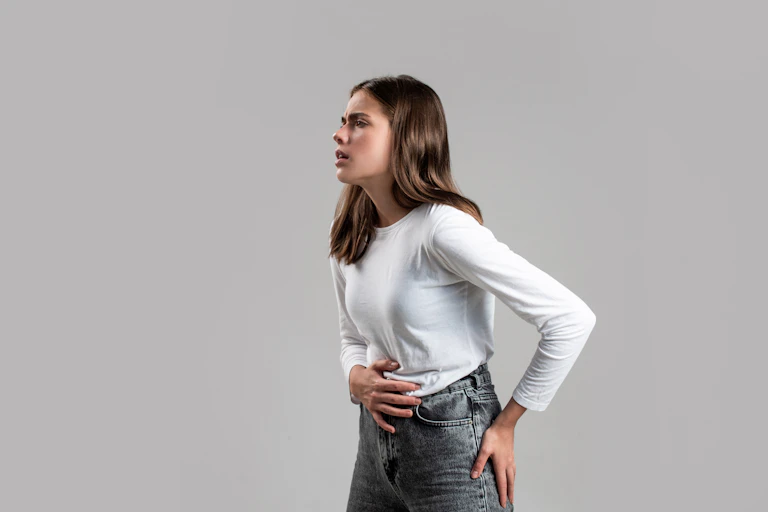 Woman holding her stomach in pain