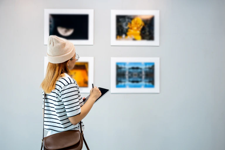 young woman writing at gallery