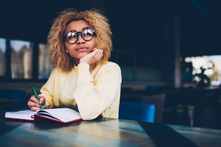 Woman writing in notebook