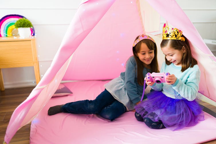 Girls playing in tent together