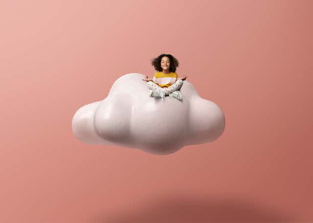 Child sitting on cloud  meditating 