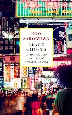 A book cover showing a photograph of a city at night, many bright lights in Chinese, a woman with an Afro hairstyle foregrounded.