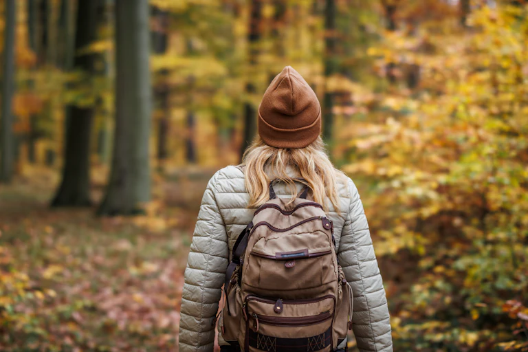 Woman walking in woods.