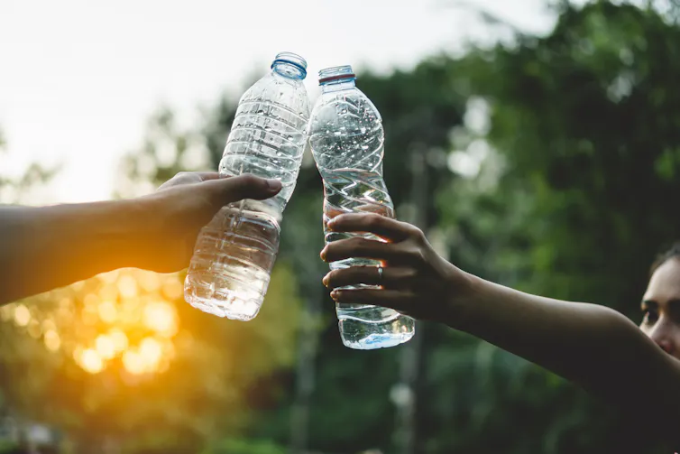 Bottles of water held up in celebration.