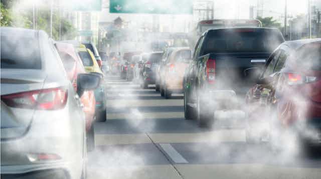 Traffic jam of cars with exhaust fumes.