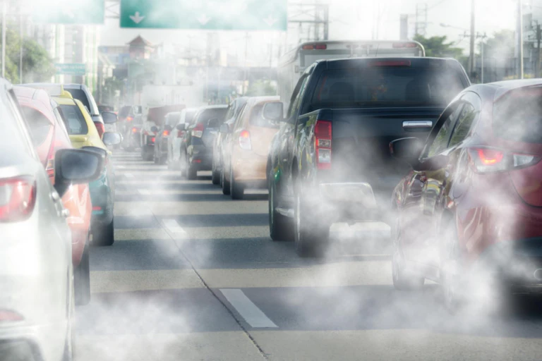 Traffic jam of cars with exhaust fumes.