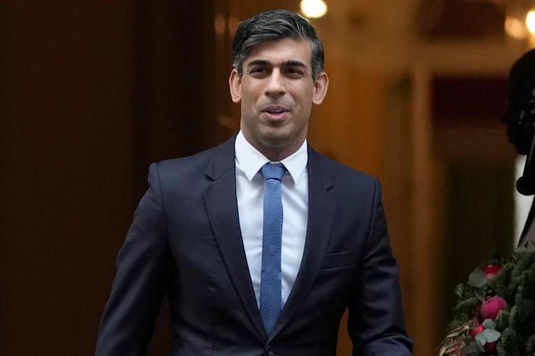 close up of prime minister Rishi Sunak in the doorway of 10 Downing Street, with a confident and relaxed expression on his face