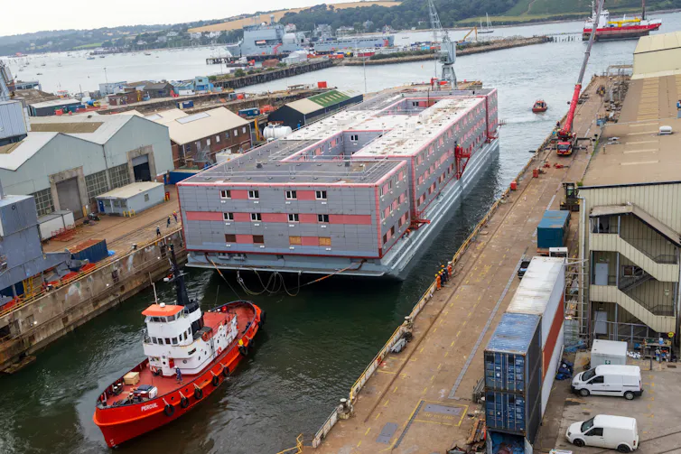 The Bibby Stockholm barge in a port
