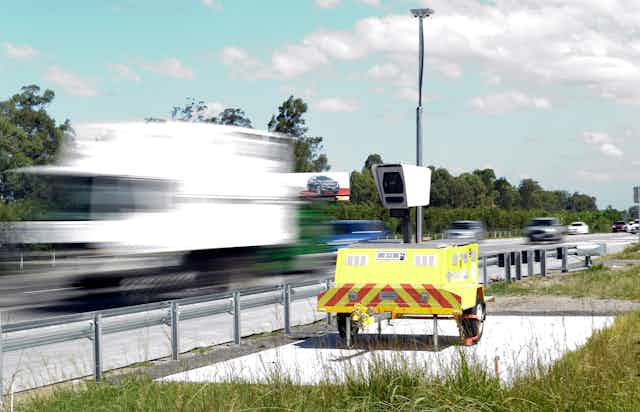 A portable road safety camera on the side of a highway