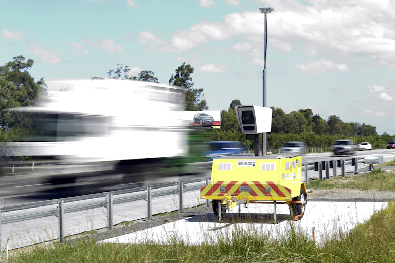 A portable road safety camera on the side of a highway