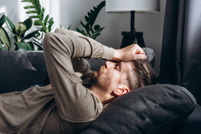 A man lying on a couch.