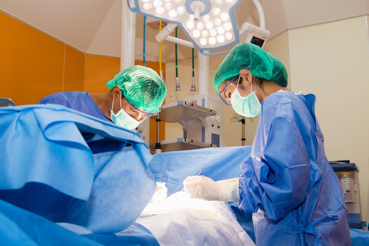 Surgeons operate on a patient