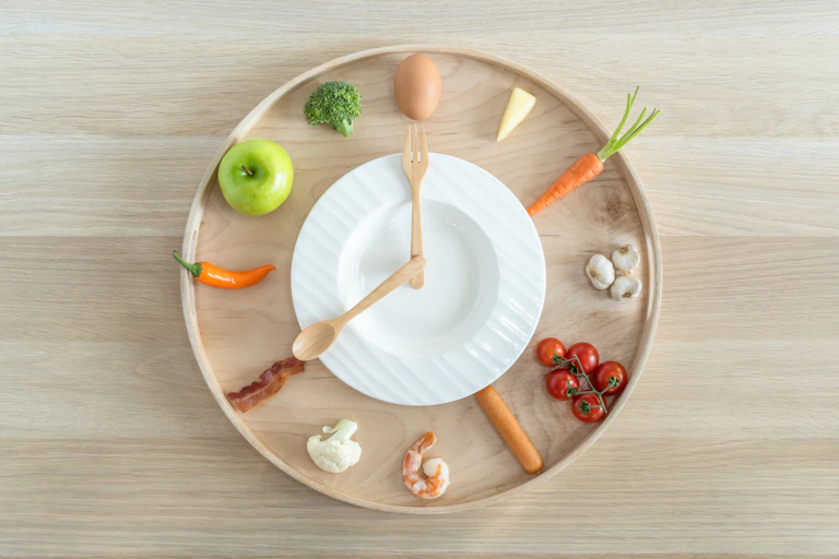 A clock where all the numbers have been replaced by healthy foods.