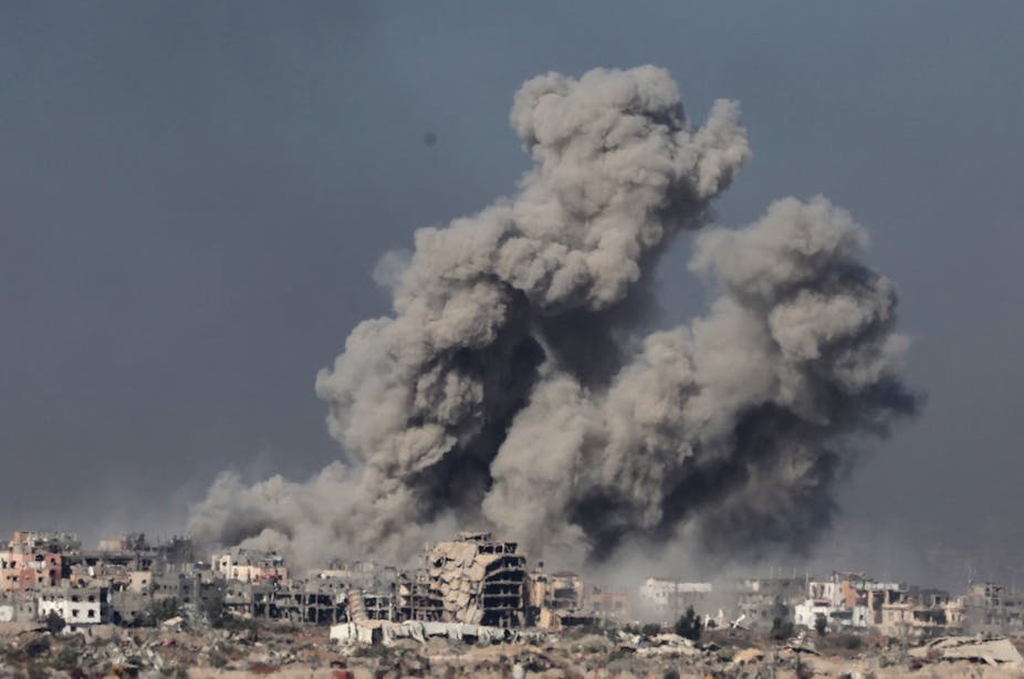 Smoke and dust rise above Gaza after an Israeli airstrike, December 11 2023.