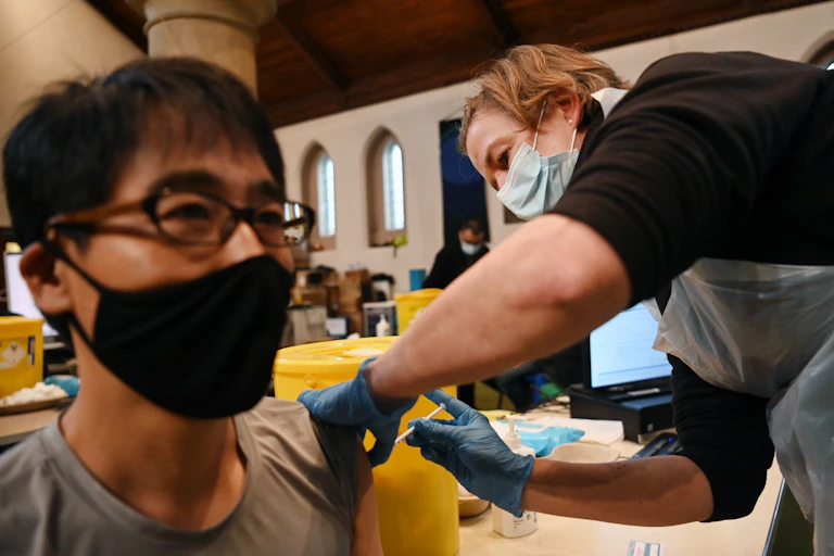 Man receiving a COVID vaccine