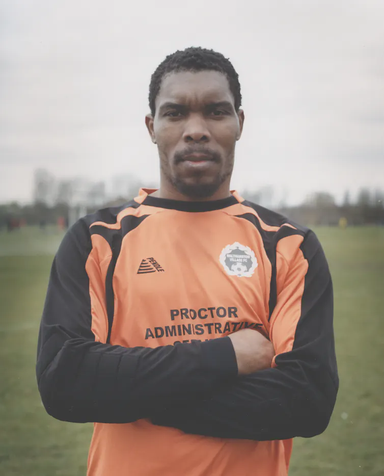 A footballer in kit on a field.