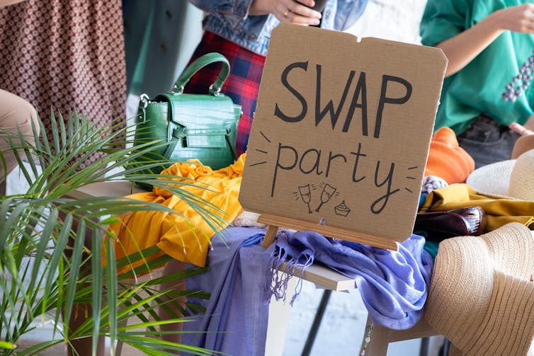 Young women swapping clothing with each other.