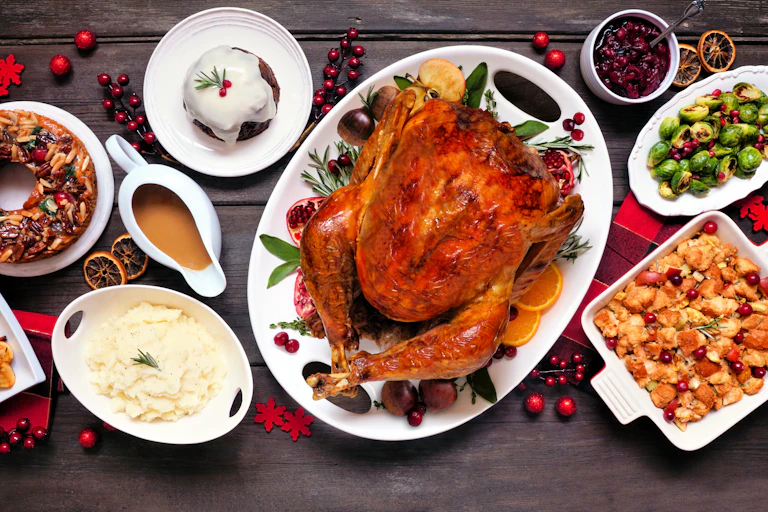 A holiday dinner with turkey, stuffing, potatoes, vegetables etc