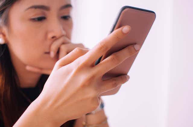 An Asian woman using a smartphone