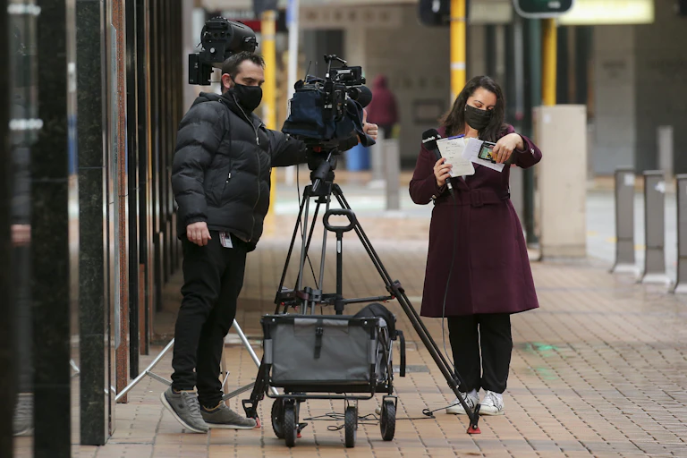 Female journalist getting ready for broadcast