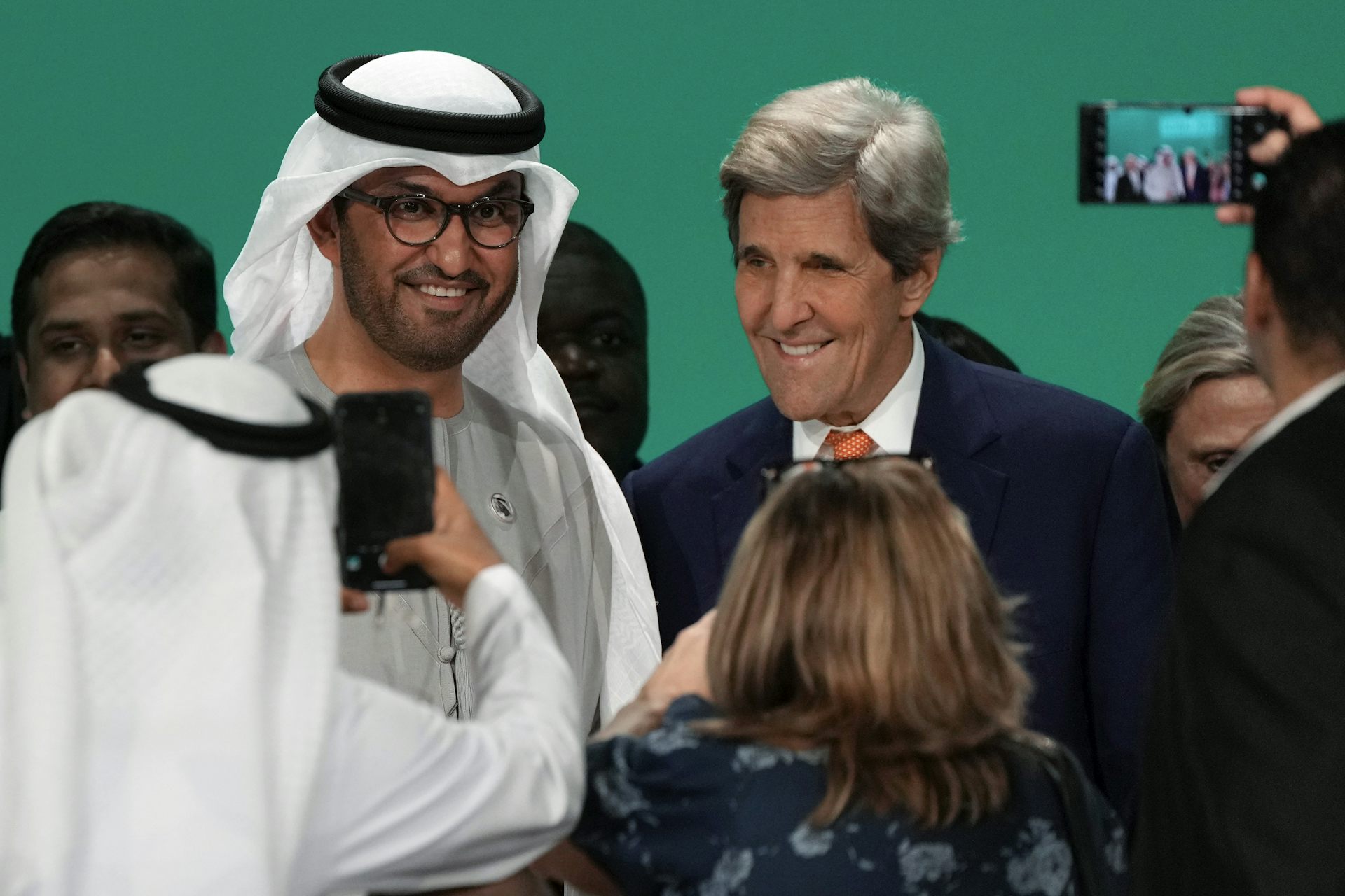 two smiling men being photographed